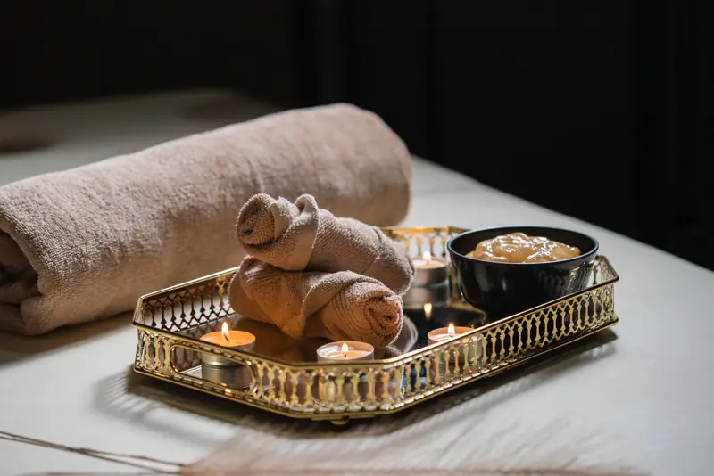 Gold tray with candles and towel