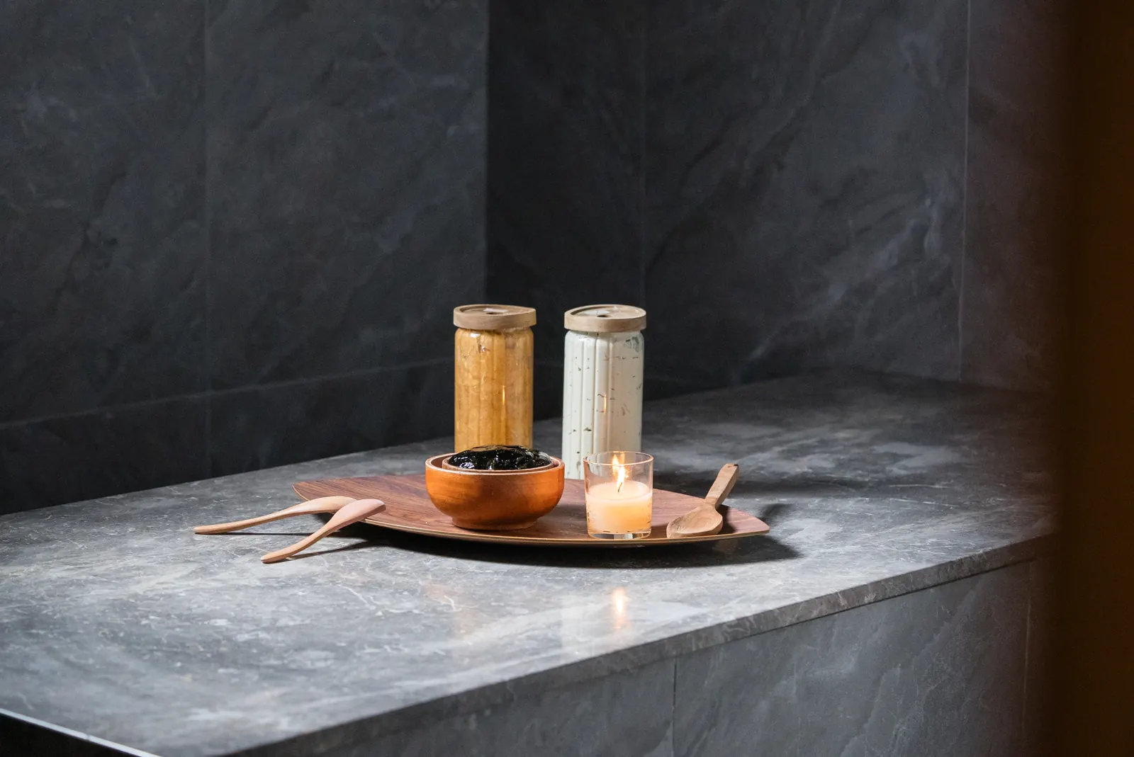 Moroccan hammam stone bench with black soap and candle